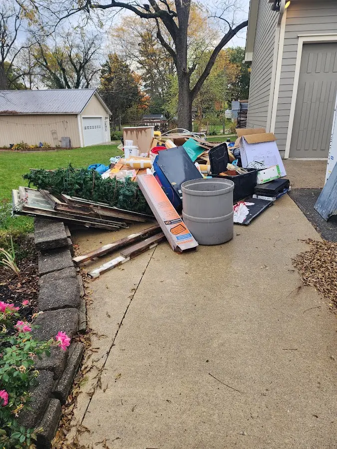 Dumpster being loaded with debris for 3 Yard Dumpster Rental in New London